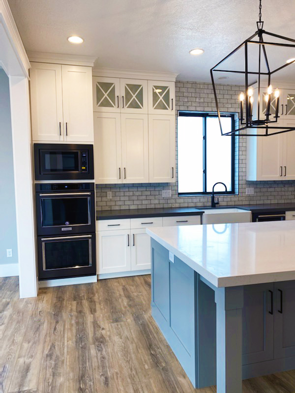 Flushed White and gray cabinets with black accessories