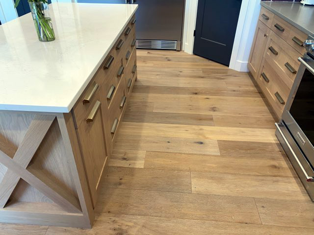 Farmhouse style kitchen cabinets blending with wooden floor